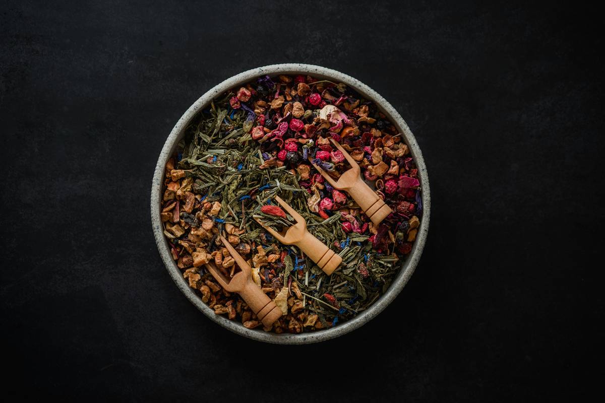 Woman practicing ayurveda ancient tip with herbal tea and journal
